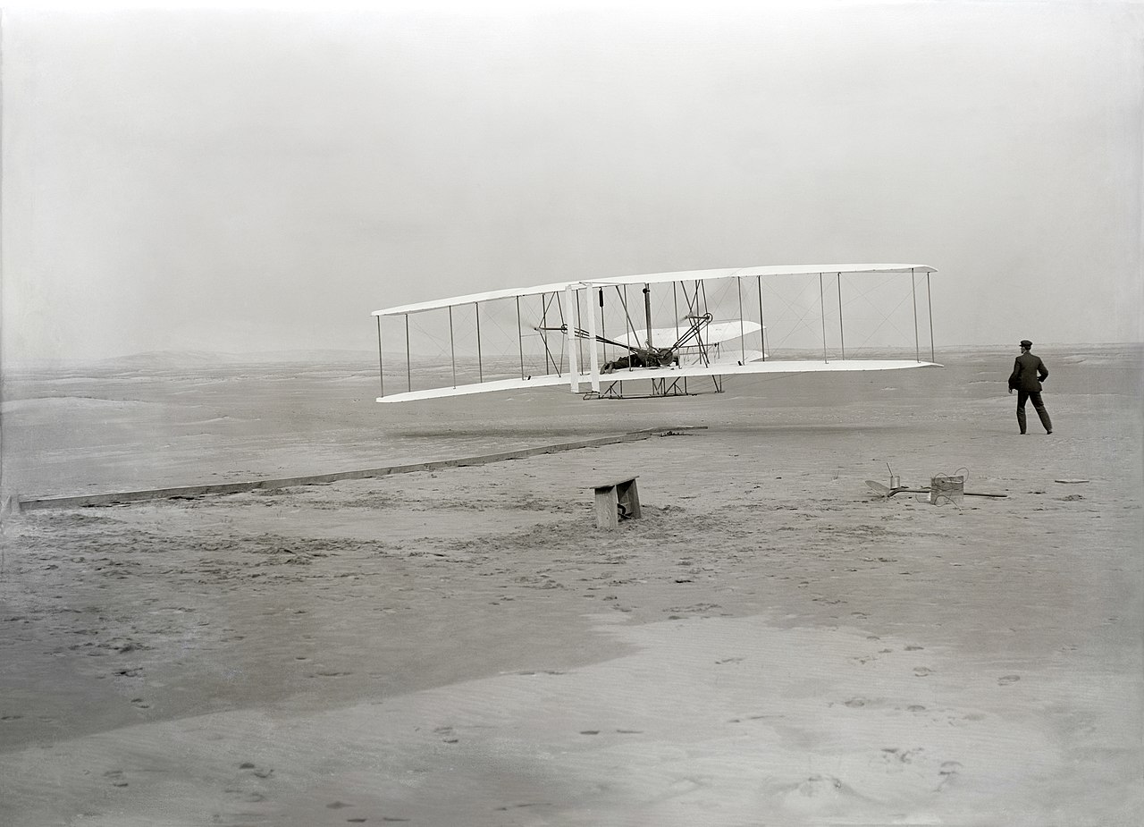 The first flight of the Wright Flyer, December 17, 1903. Photographer name was John T. Daniels